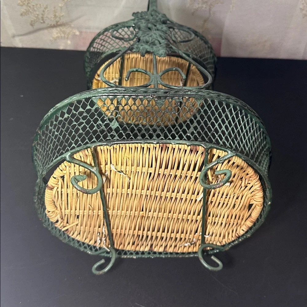 Wire Basket stand made of green-painted metal wire with a woven wicker base
